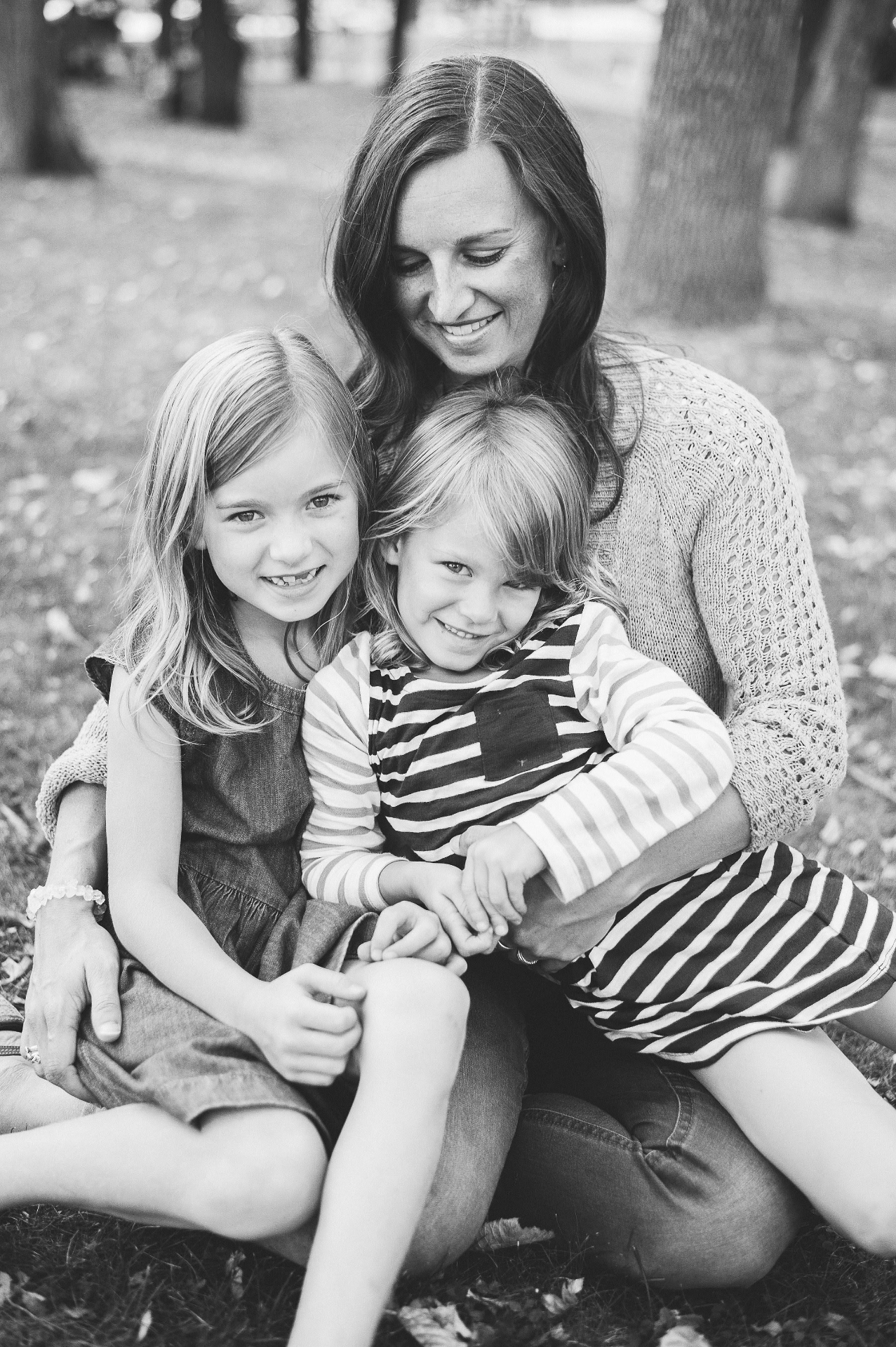 Mother and daughters under the trees